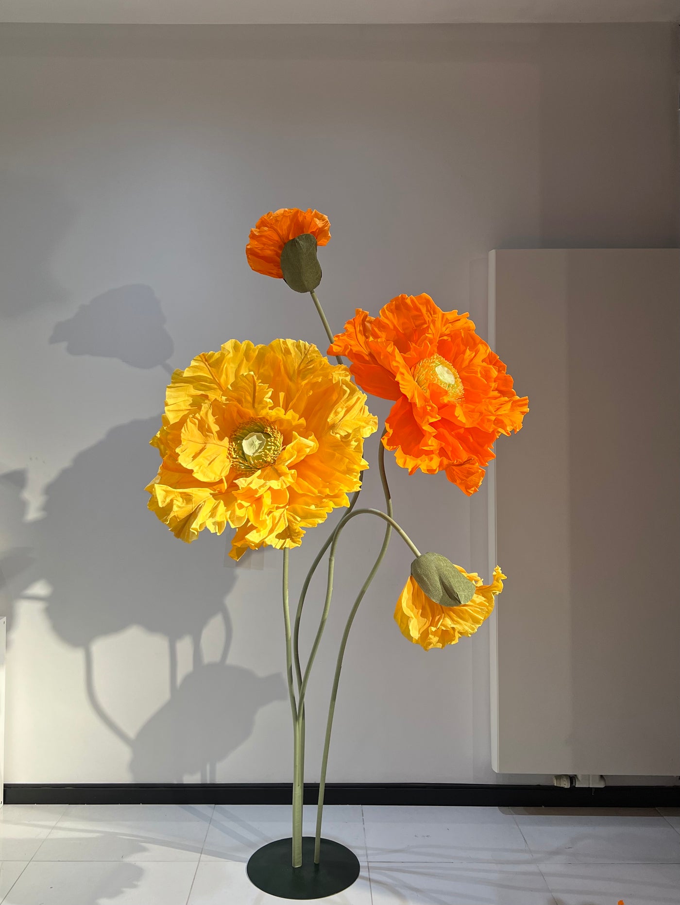Standout Decor: Giant Orange and Yellow Paper Flowers for Events and Trade Shows