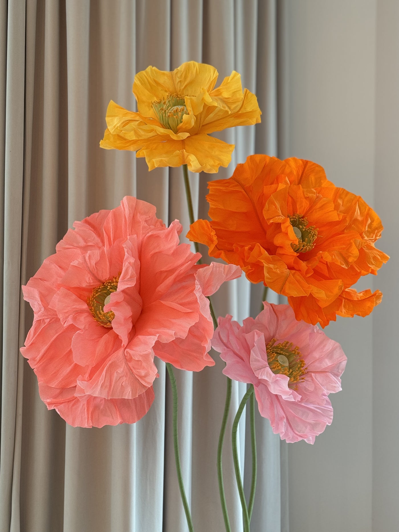 Handcrafted big paper flowers in yellow and hot pink for party decoration