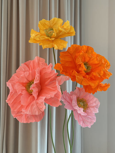 Handcrafted big paper flowers in yellow and hot pink for party decoration