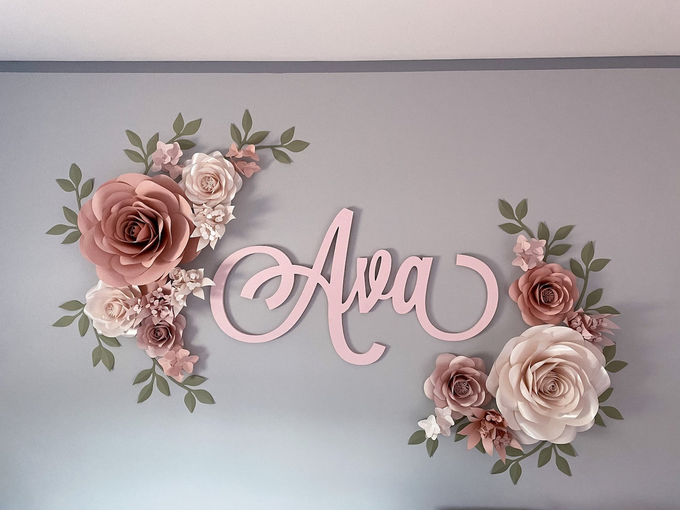 Paper flower  hanging above the crib in the nursery, creating a soothing and enchanting atmosphere for the little one