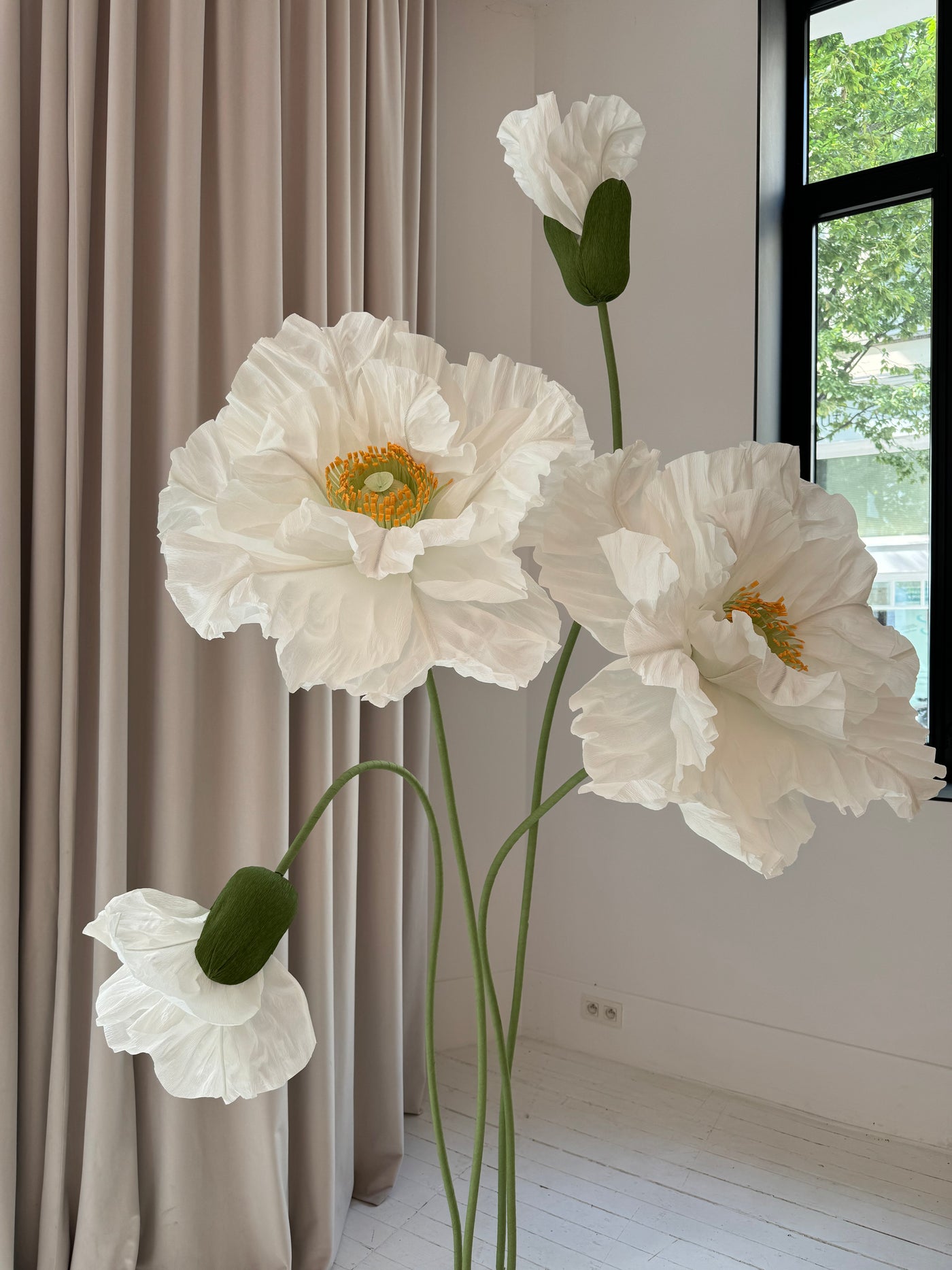 Large white paper flowers creating a beautiful backdrop for weddings.