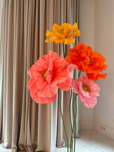 Life-sized paper flower centerpieces in yellow and bright pink for stylish party decor