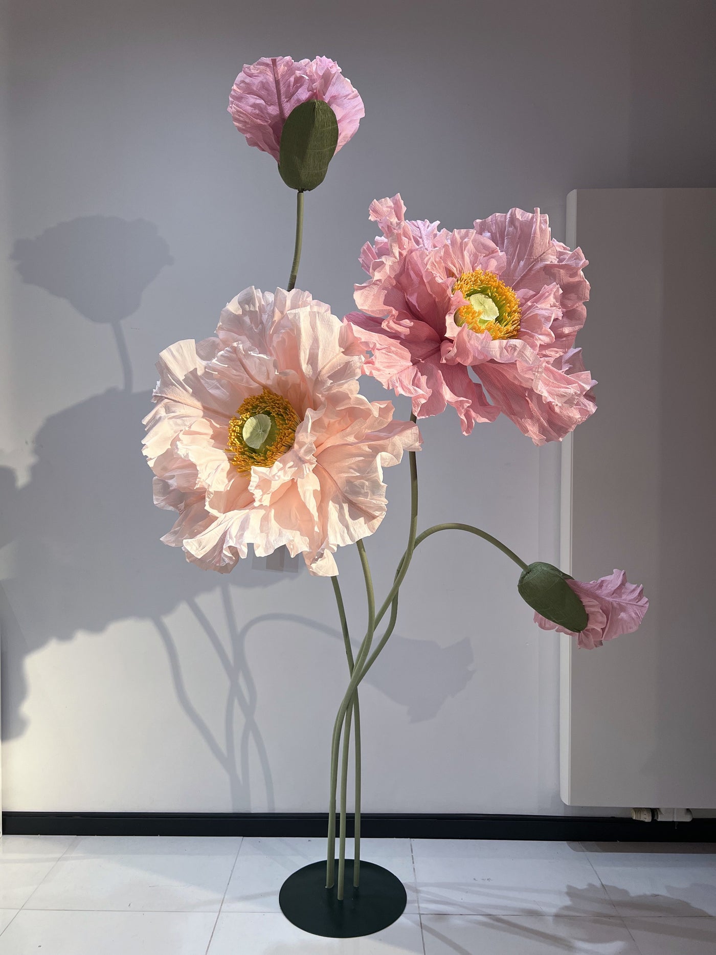 Oversized standing paper flowers adding elegance to a window display