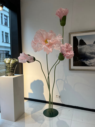 Oversized standing paper flowers in window display