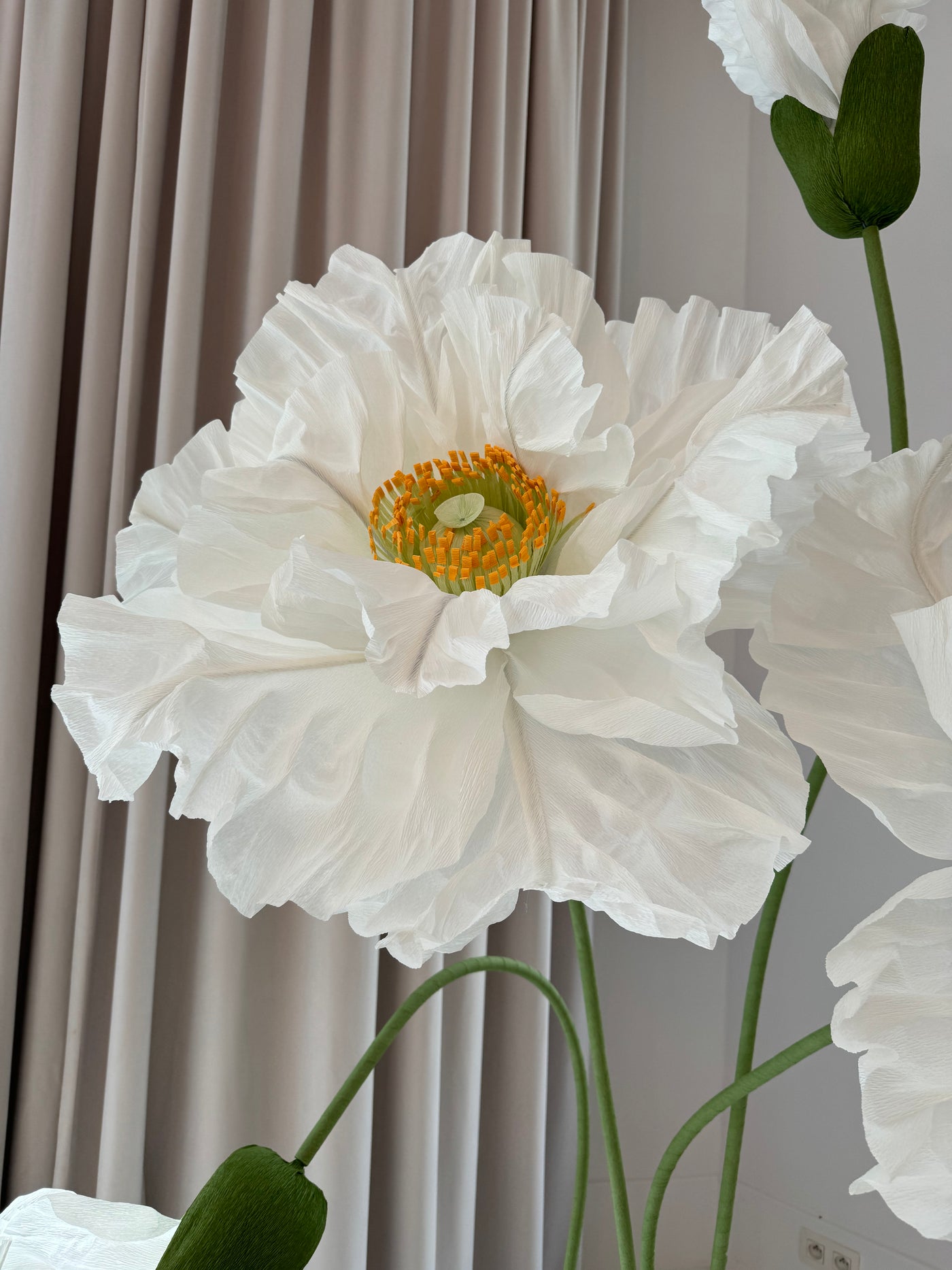 Standing white paper flowers in a set of 4, adding style to any space