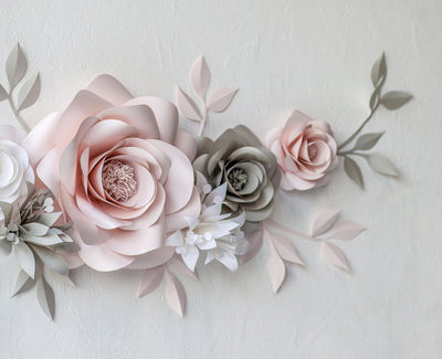 Elegant Blooms: Blush and Light Grey Paper Flowers Enhancing Baby Room Decor